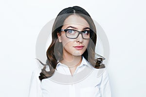Young beautiful business woman in stylish glasses posing in studio.