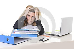 Young beautiful business woman suffering stress working at office computer desk load of paperwork