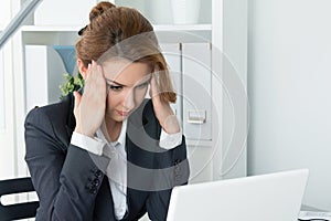 Young beautiful business woman trying to concentrate photo