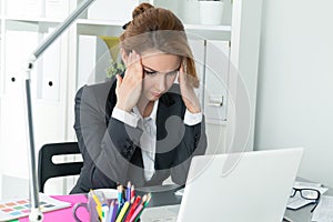 Young beautiful business woman trying to concentrate photo