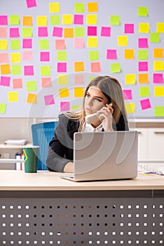 The young beautiful businesslady in conflicting priorities concept