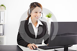 Young beautiful businesswoman with headset in office