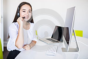 Young beautiful businesswoman with headset call center operator in office