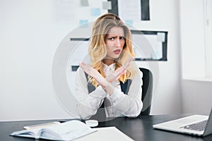 Young beautiful businesswoman manager with red lipstick works in her modern office, holding her arms crossed showing refusal, body