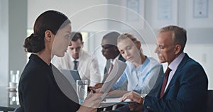 Young beautiful businesswoman reading contract at meeting in office