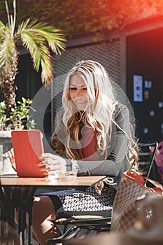 Young and beautiful businesswoman using her digital tablet in ca