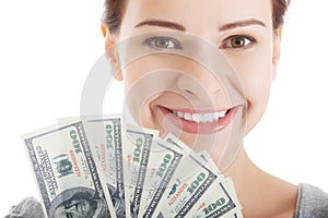 Young beautiful casual woman holding large sum of money.