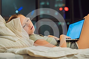 Young beautiful, caucasian, red haired, internet addicted woman working bored, sleepless and tired on her laptop in bed