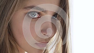 Young beautiful caucasian woman looking at camera, smiling, portrait, temptation, daylight, near window, curtain