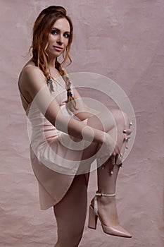 Young beautiful caucasian woman, in a pink dress