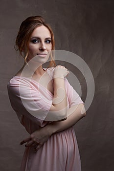 Young beautiful Caucasian woman, in a pink dress
