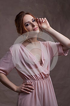 Young beautiful Caucasian woman, in a pink dress