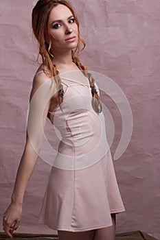 Young beautiful caucasian woman, in a pink dress