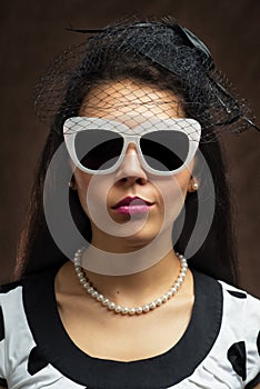 Young beautiful caucasian woman posing, retro styling