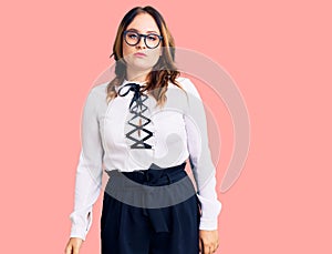 Young beautiful caucasian woman wearing business shirt and glasses with serious expression on face
