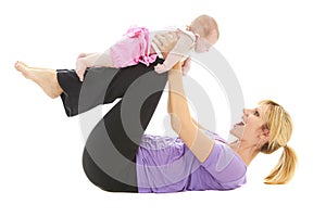 Young beautiful caucasion mom doing baby yoga