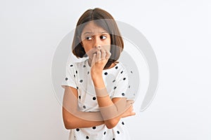 Young beautiful child girl wearing casual t-shirt standing over isolated white background looking stressed and nervous with hands