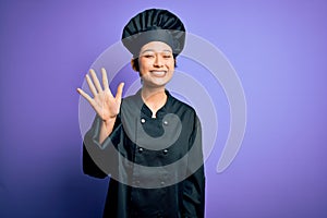 Young beautiful chinese chef woman wearing cooker uniform and hat over purple background showing and pointing up with fingers