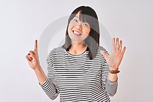 Young beautiful chinese woman wearing black striped t-shirt over isolated white background showing and pointing up with fingers