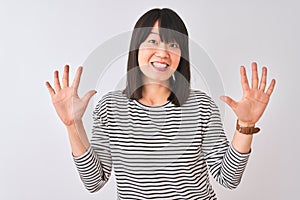 Young beautiful chinese woman wearing black striped t-shirt over isolated white background showing and pointing up with fingers