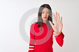 Young beautiful chinese woman wearing red dress standing over isolated white background doing stop sing with palm of the hand