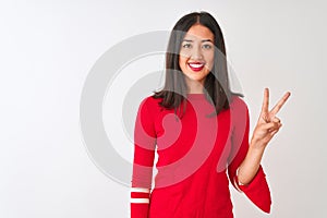 Young beautiful chinese woman wearing red dress standing over isolated white background showing and pointing up with fingers