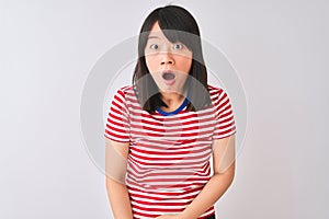 Young beautiful chinese woman wearing red striped t-shirt over isolated white background afraid and shocked with surprise and