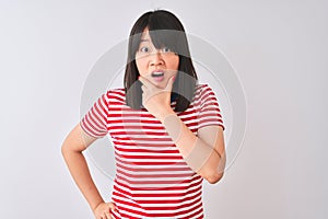Young beautiful chinese woman wearing red striped t-shirt over isolated white background Looking fascinated with disbelief,