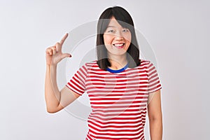 Young beautiful chinese woman wearing red striped t-shirt over isolated white background smiling and confident gesturing with hand