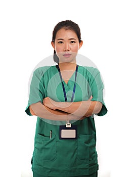 Young beautiful and confident Asian Chinese medicine doctor woman or hospital nurse in green scrubs posing serious  in corporate