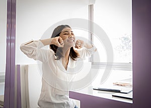 Young beautiful confident business woman sitting raised fists victory with smile on her face