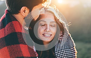 Young beautiful couple with checkered plaid walking outside on beautiful sunset. Perfect romantic landscape for lovestory. Two photo