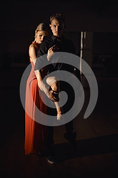 Young beautiful couple dancing with passion