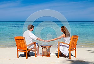 Young beautiful couple enjoying on a tropical beac