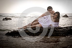 Young beautiful couple flirting at the beach