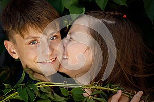 Young beautiful couple in foliage close up