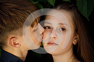 Young beautiful couple in foliage close up