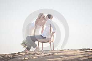 Young beautiful couple hanging out together at the beach