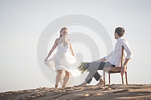 Young beautiful couple hanging out together at the beach