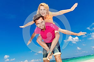 Young beautiful couple having fun on a tropical beach.
