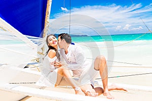 Young beautiful couple having fun on a tropical beach . Tropical