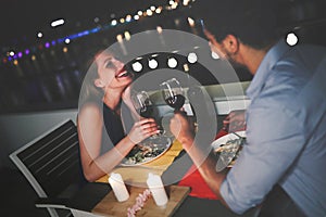 Young beautiful couple having romantic dinner on rooftop