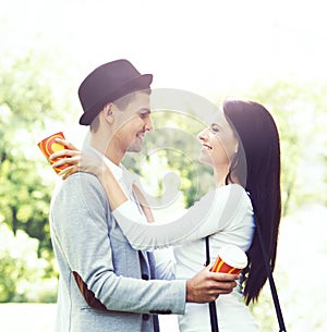 Young beautiful couple of hipsters: hugging in the park.