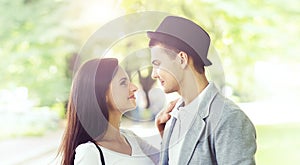 Young beautiful couple of hipsters: hugging in the park.