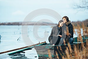 Young beautiful couple on the ice of a frozen lake