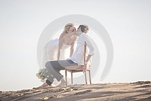 Young beautiful couple kissing at the beach