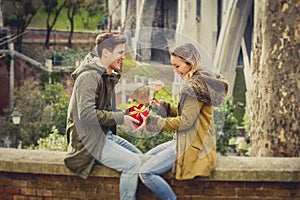 Young beautiful couple in love celebrating Valentines day presents