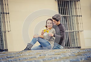 Young beautiful couple in love on street together celebrating Valentines day with Champagne toast