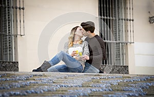Young beautiful couple in love on street together celebrating Valentines day with Champagne toast
