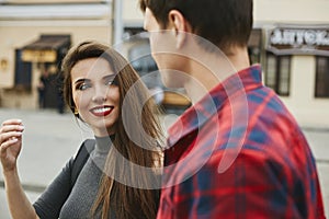 Young beautiful couple of lovers at the dating. Young woman with a perfect white smile and red lips and a handsome young